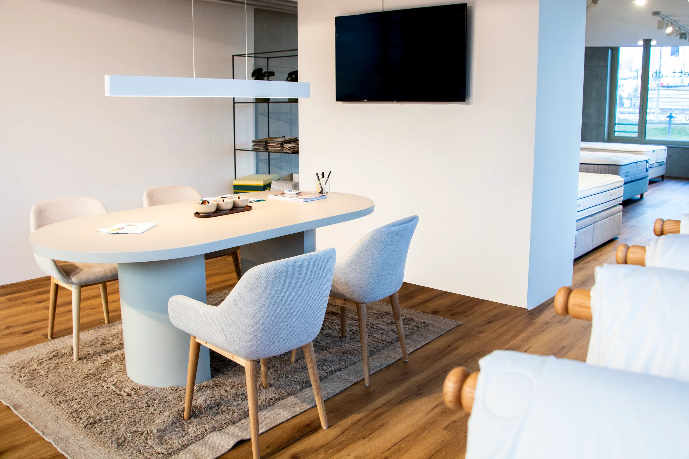 Beratungsbereich im Showroom von das-bett.ch in Zürich-Altstetten mit Tisch, Stühlen und Betten